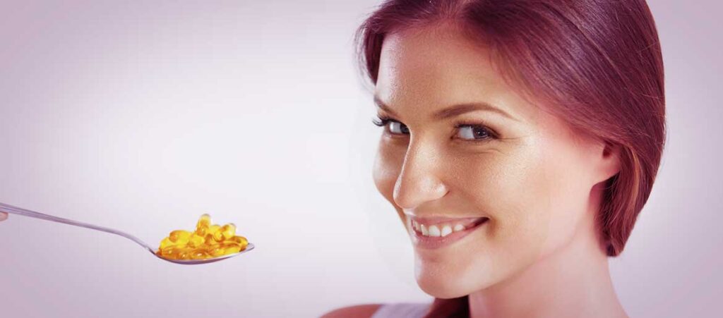 Girl smiling taking a spoonful of natural supplements